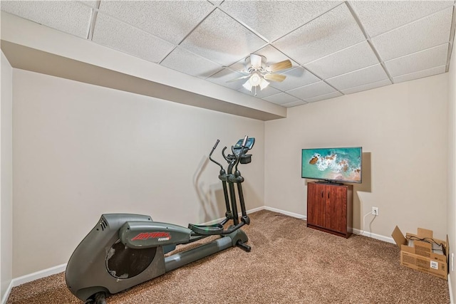 workout room with a drop ceiling, baseboards, and carpet floors