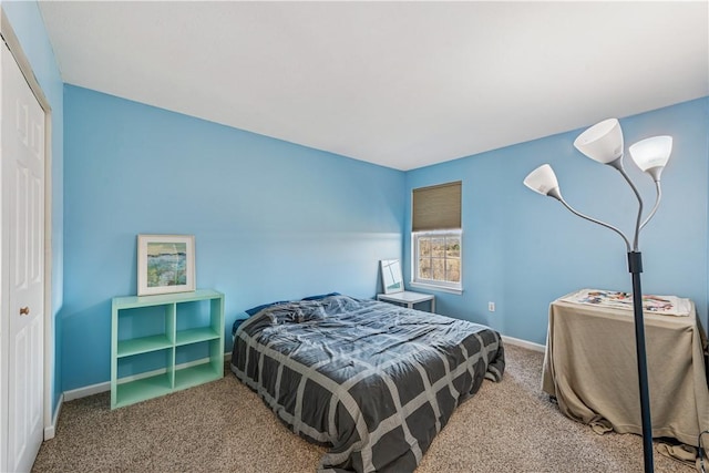 bedroom with a closet, baseboards, and carpet flooring