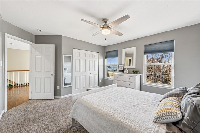 bedroom featuring a closet, ceiling fan, baseboards, and carpet