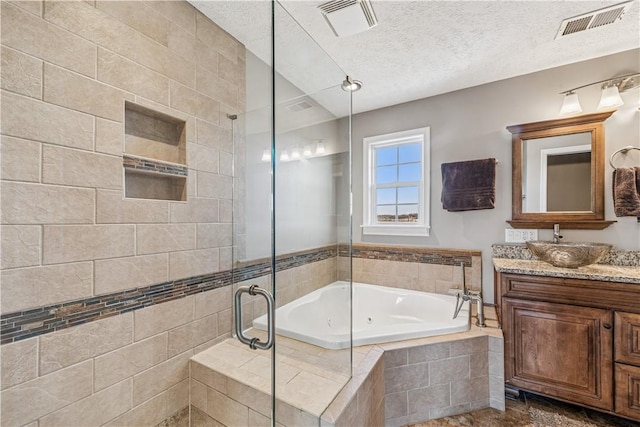 bathroom with visible vents, a stall shower, a textured ceiling, and a tub with jets