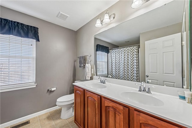 bathroom featuring a sink, visible vents, and toilet