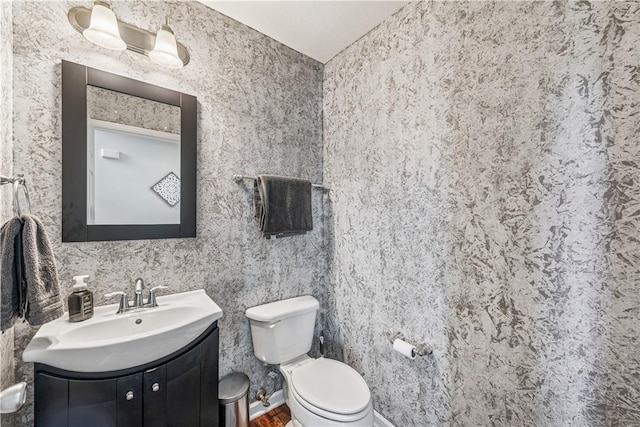 bathroom with toilet and vanity