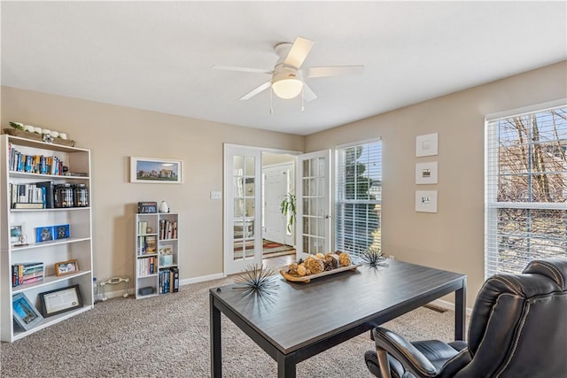 office space featuring baseboards, ceiling fan, and carpet flooring