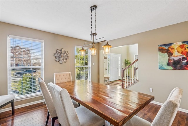 dining space featuring stairway, baseboards, and dark wood-style floors