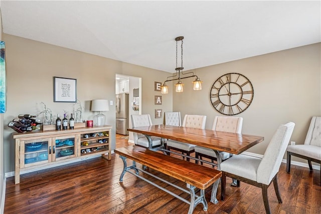 dining area featuring baseboards and dark wood finished floors