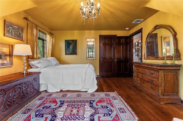 bedroom featuring an inviting chandelier, visible vents, and dark wood-type flooring