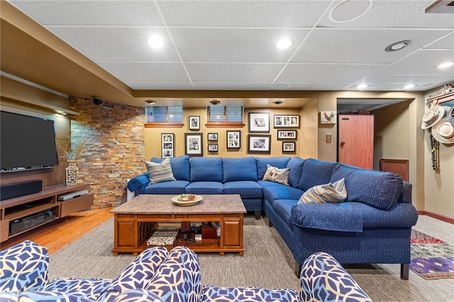 living room with light wood finished floors, recessed lighting, and a drop ceiling