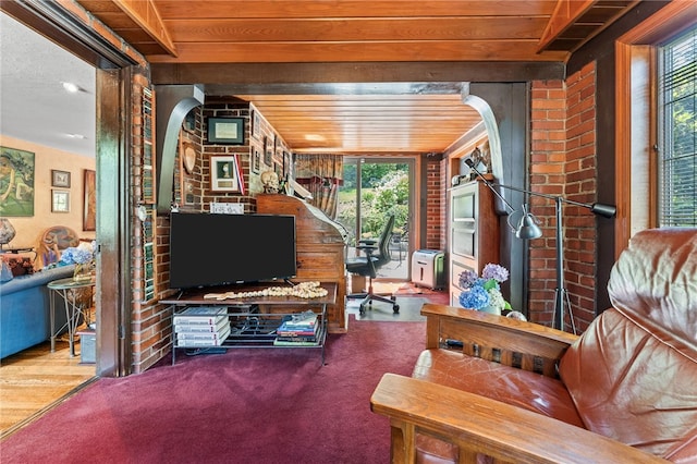 living room with arched walkways, plenty of natural light, and wooden ceiling