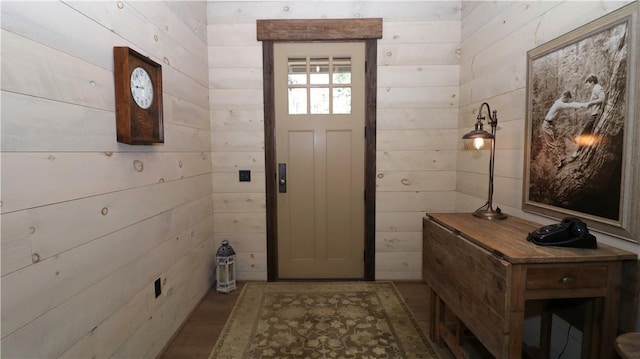 foyer featuring wood walls