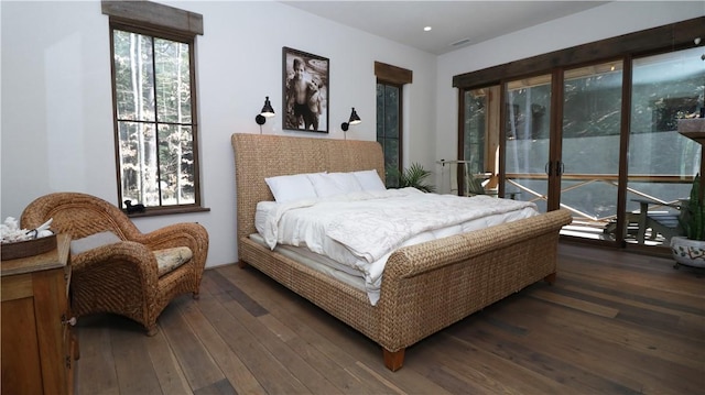 bedroom featuring visible vents and dark wood-style flooring