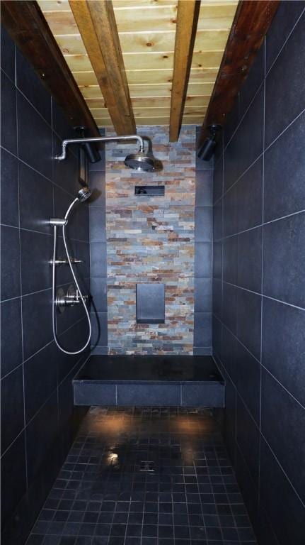 bathroom featuring beamed ceiling, wood ceiling, and a tile shower