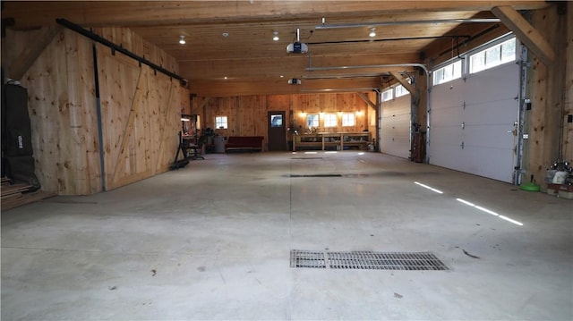 garage featuring wooden walls and a garage door opener