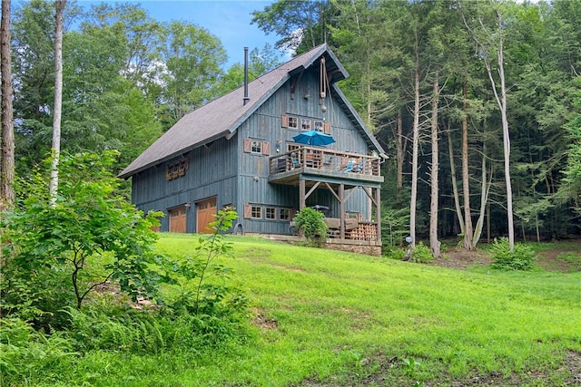 000 Wonder Ln, Punxsutawney Area School District, PA 15767 - back of property with a garage, a yard, a deck, and a wooded view