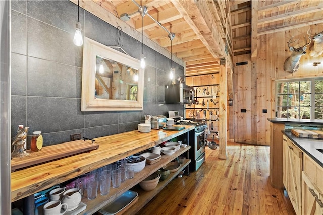 000 Wonder Ln, Punxsutawney Area School District, PA 15767 - kitchen with appliances with stainless steel finishes, hardwood / wood-style flooring, pendant lighting, wooden walls, and butcher block counters