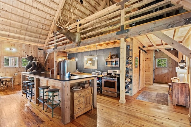 000 Wonder Ln, Punxsutawney Area School District, PA 15767 - kitchen featuring stainless steel appliances, light wood-type flooring, a wooden ceiling with exposed beams, wood walls, and high vaulted ceiling