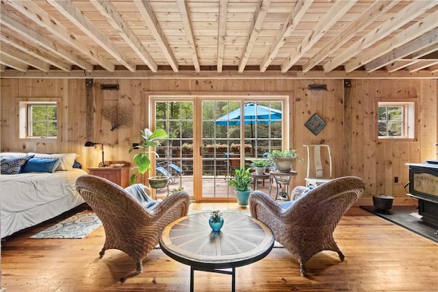 000 Wonder Ln, Punxsutawney Area School District, PA 15767 - living area with wood walls, hardwood / wood-style flooring, plenty of natural light, a wood stove, and a wood ceiling with exposed beams
