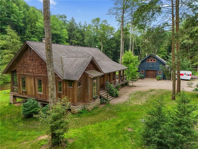 000 Wonder Ln, Punxsutawney Area School District, PA 15767 - view of front of house with roof with shingles, an outdoor structure, covered porch, driveway, and a detached garage