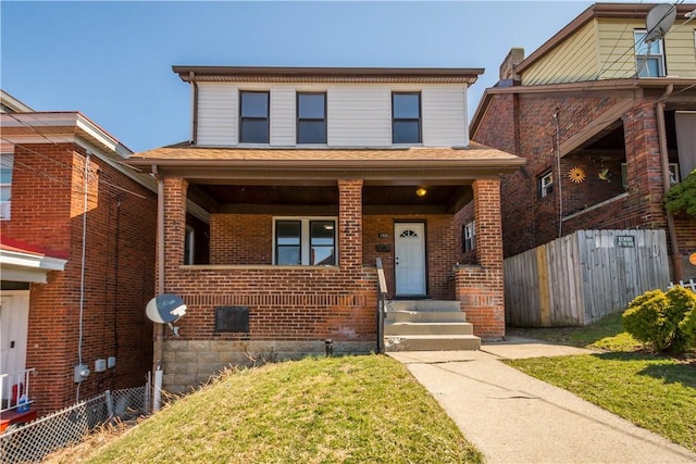 view of front of house featuring brick siding, a porch, and fence