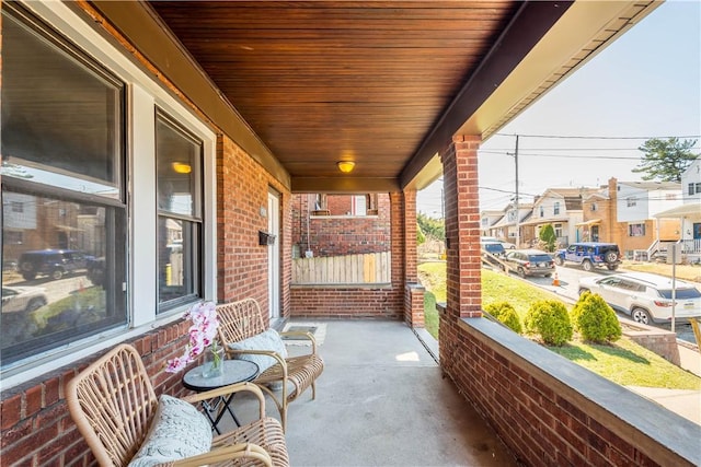 view of patio with a residential view and a porch