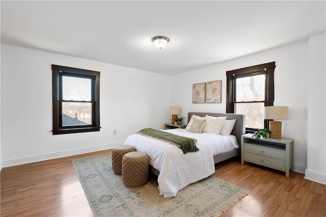 bedroom with wood finished floors and baseboards