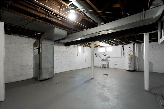 basement featuring heating unit, electric water heater, and a sink