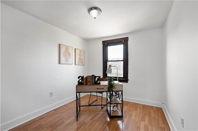 office area with baseboards and wood finished floors