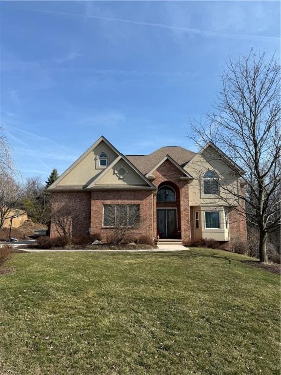 view of front of house featuring a front yard and brick siding