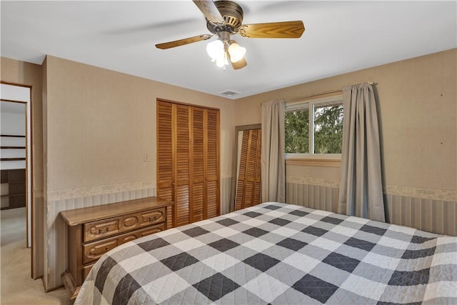 bedroom with a closet, visible vents, and ceiling fan