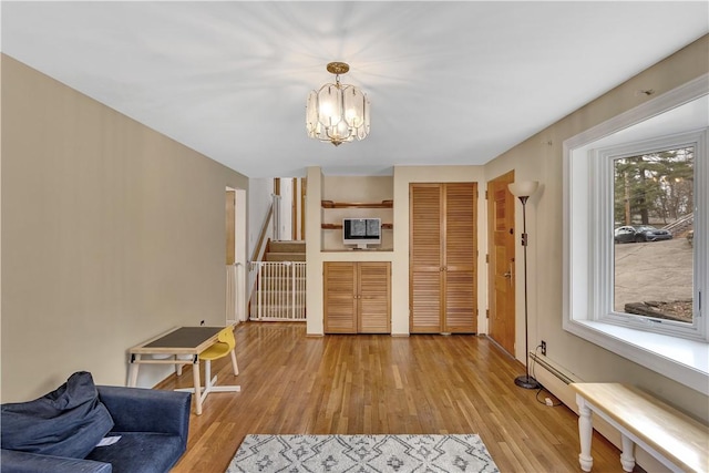 interior space with stairs, an inviting chandelier, and light wood-type flooring