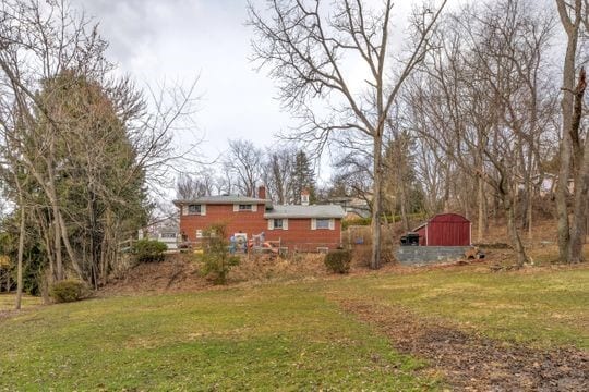 view of yard featuring a barn and an outbuilding