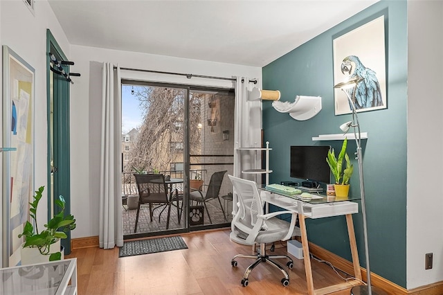 office space featuring baseboards and wood finished floors