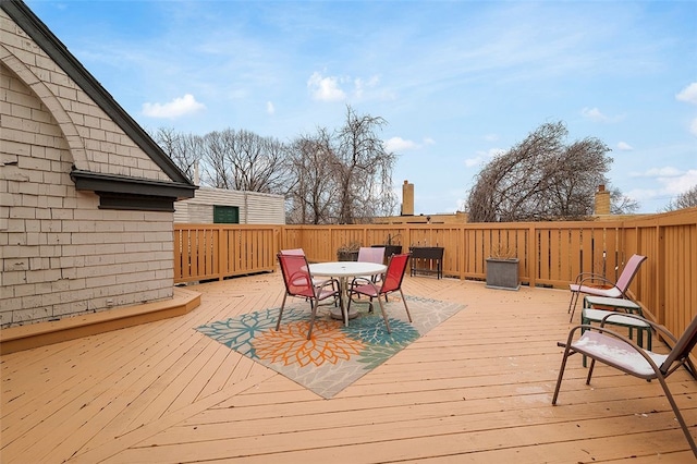 wooden deck featuring outdoor dining area