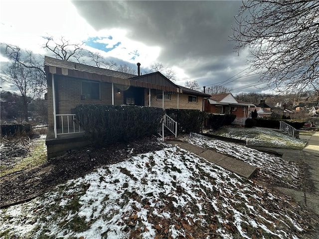 rear view of property with board and batten siding and brick siding