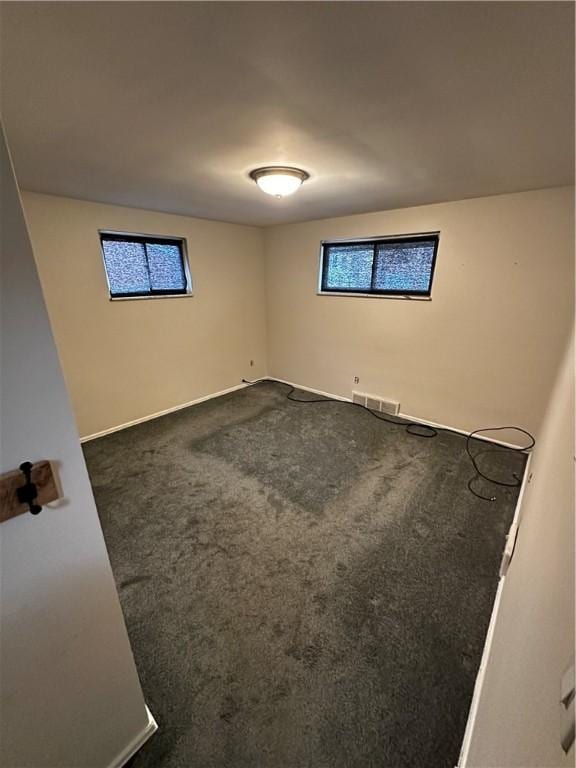 interior space featuring visible vents and dark carpet