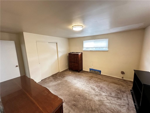 unfurnished bedroom with baseboards, a closet, and carpet floors