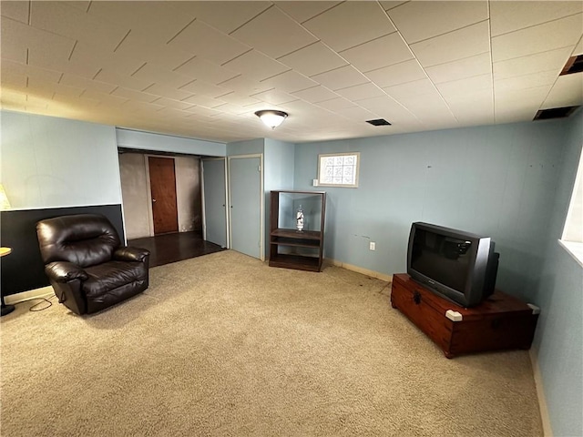 living area with carpet flooring, baseboards, and visible vents