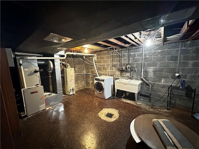 unfinished below grade area with heating unit, washer / dryer, gas water heater, and a sink