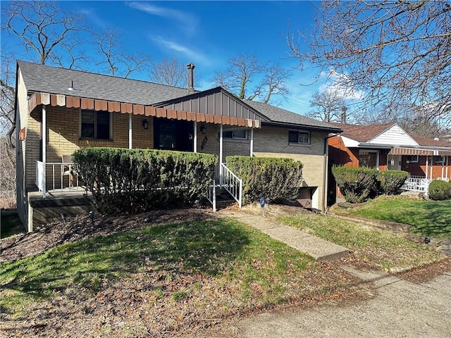 5534 Pocusset St, Squirrel Hill, PA 15217 - ranch-style home with a front yard, brick siding, board and batten siding, roof with shingles, and a porch