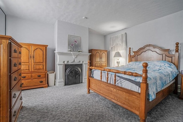 carpeted bedroom featuring a fireplace