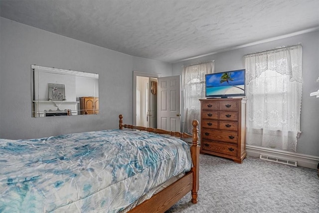 carpeted bedroom featuring visible vents, a textured ceiling, and baseboards