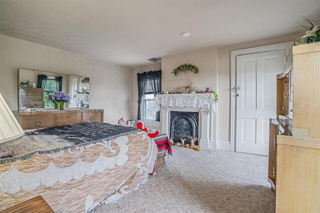 carpeted bedroom with a fireplace