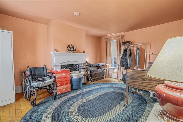 interior space featuring baseboards, wood finished floors, and a fireplace