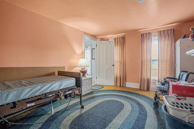 bedroom featuring baseboards and wood finished floors