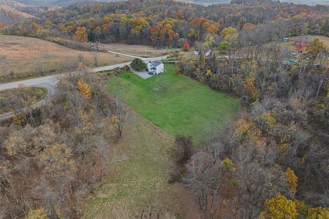 birds eye view of property featuring a wooded view