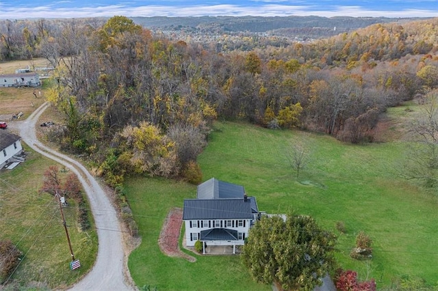 drone / aerial view with a wooded view