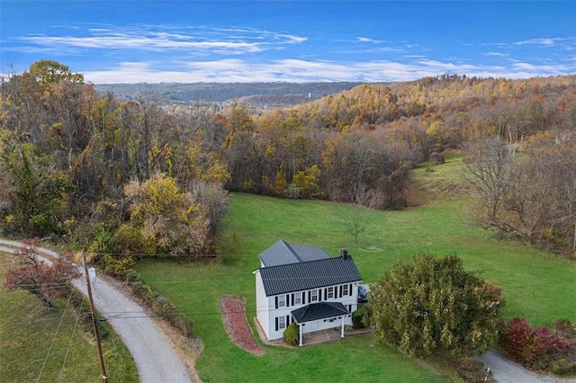 aerial view featuring a wooded view