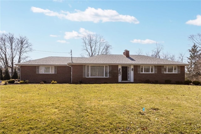 ranch-style home featuring a front lawn, brick siding, and a chimney