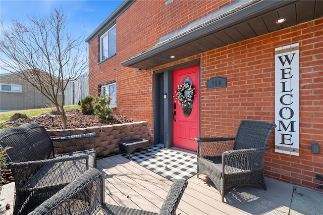 entrance to property featuring brick siding