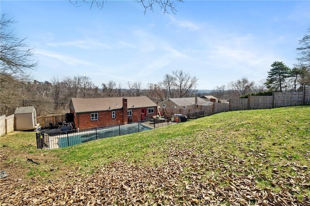 view of yard featuring a fenced in pool, a shed, an outdoor structure, a fenced backyard, and a patio area