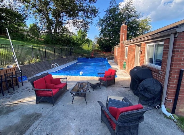 view of swimming pool featuring an outdoor living space, a patio, a fenced backyard, grilling area, and a fenced in pool